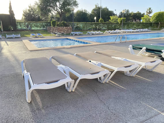 sunbeds beside pool